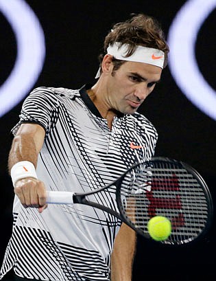 Roger Federer makes a backhand return to Tomas Berdych during their third-round match Friday at the Australian Open in Melbourne, Australia.