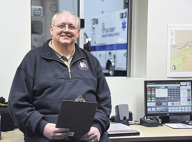 Jerry Johnston poses in the dispatch bay at the Cole County EMS building on Southridge Drive.