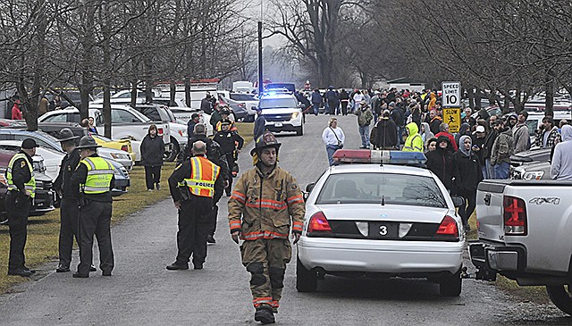 Parents wait Friday at Lions Park in West Liberty, Ohio, to pick up their children after a shooting at West Liberty-Salem Schools. A male student who was shot and wounded was hospitalized Friday, and another student suspected in the shooting was in custody, officials said.