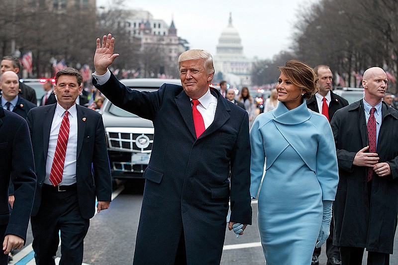 President Donald Trump and first lady Melania Trump walk along the inauguration day parade route Friday on Pennsylvania Avenue after he was sworn in as the 45th President of the United States in Washington. 