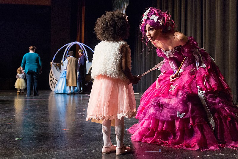 Loryn Nelson, 4, speaks with Elicia Bilyeu, who plays the Fairy Godmother in Texas High School's production of "Cinderella," on Saturday at the Sullivan Performing Arts Center in Texarkana, Texas. "Tea with Cinderella" gave children a chance to take photographs with the characters in the play. Tickets are available for the performances at 2:30 p.m. today and at 7 p.m. Monday.