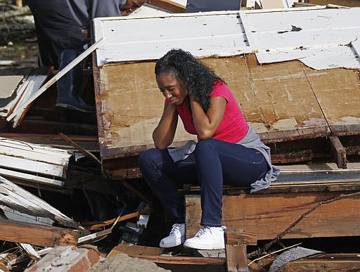 Shanise McMorris grieves on the slab of her Hattiesburg, Miss., home after an early tornado hit the city, Saturday, Jan. 21, 2017. The tornado was part of a wall of stormy weather traveling across the region, bringing with it rain and unstable conditions. 