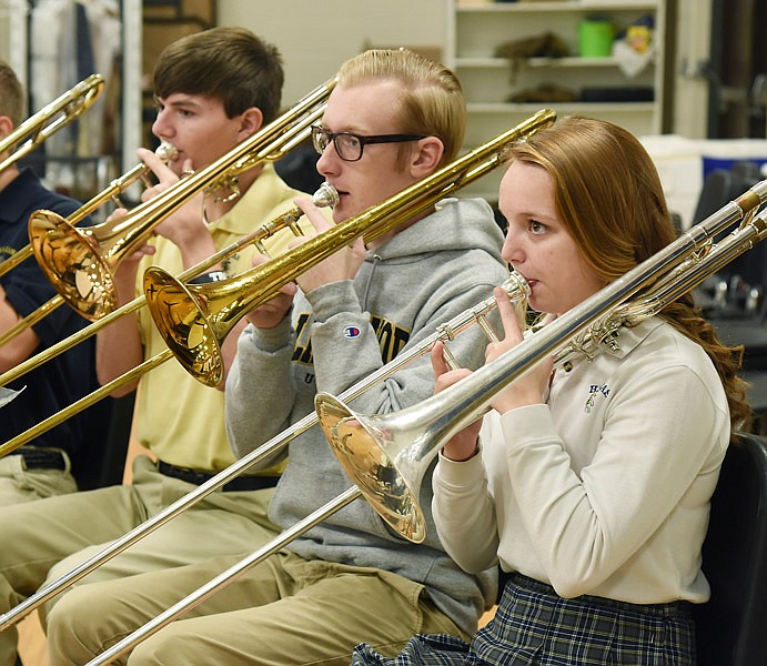 Kelsi Lennon, Jordan Cowell and Andrew Roussin play the trombone during band class Thursday morning, Jan. 19, 2017 at Helias High School. Lennon a freshman, Roussin a sophomore and Cowell a senior, have all been working to improve their skills in the band, which has seen its numbers grow in recent years.