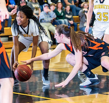 Fulton senior guard Dionne Vaughn (left) battles Owensville sophomore guard Ella Wright for a loose ball during the Lady Hornets' 62-46 non-conference loss to the Dutchgirls on Friday night at Roger D. Davis Gymnasium. Vaughn broke out for a game-high 35 points to guide Fulton.