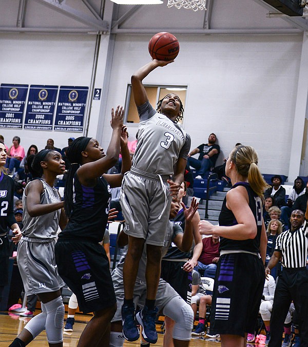 Lincoln Blue Tigers guard Khadijah Ellison leaps above the arms of a Southwest Baptist Bearcat defender before turning in a layup on Saturday, Jan. 21, 2017.  