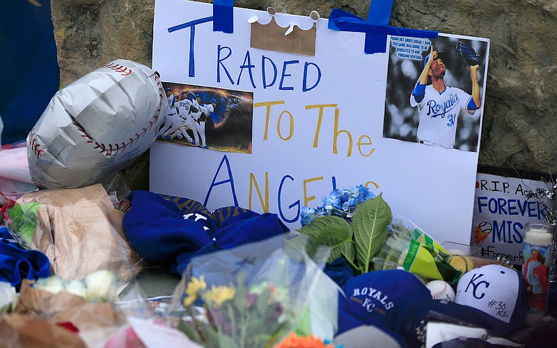 Signs and flowers make up a memorial for Kansas City Royals baseball pitcher Yordano Ventura outside Kauffman Stadium in Kansas City, Mo., Sunday, Jan. 22, 2017. Ventura died Sunday in a car crash on a stretch of highway near the town of San Adrian in his native Dominican Republic. He was 25.