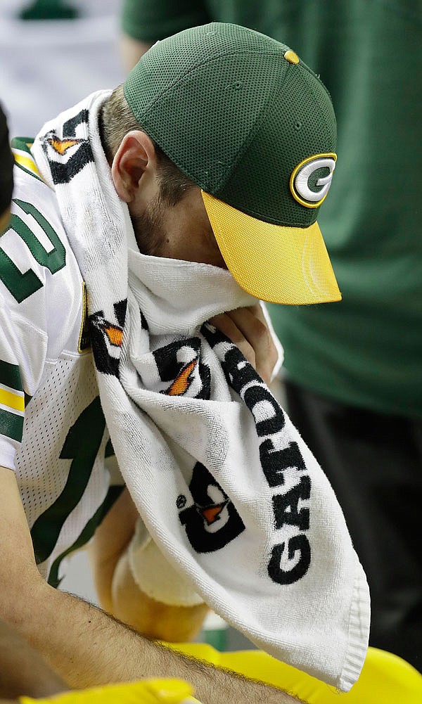 Packers quarterback Aaron Rodgers wipes his face on the bench during the first half of Sunday's NFC championship game against the Falcons in Atlanta.