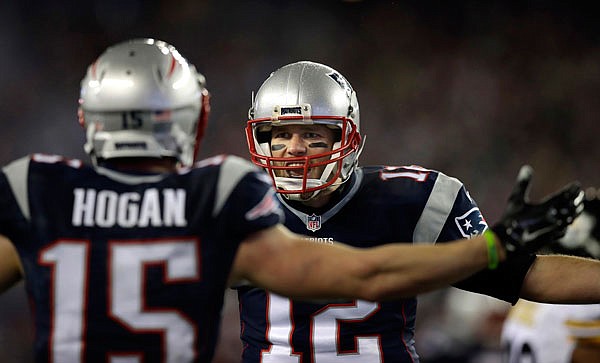 Patriots quarterback Tom Brady celebrates with wide receiver Chris Hogan after throwing him a touchdown pass during the first half of Sunday's AFC championship game against the Steelers in Foxborough, Massachusetts.