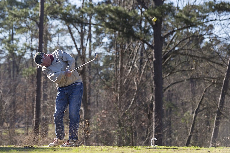 Randy Moore practices golf Monday at the Texarkana Golf Ranch. "I love being able to get out in the nice weather," he said. While temperatures Monday were more amenable to golfing, the course was still damp from previous day's rain. 