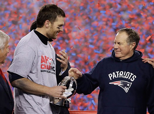 Patriots quarterback Tom Brady holds the AFC Championship trophy as he celebrates with head coach Bill Belichick after Sunday's win against the Steelers in Foxborough, Mass.