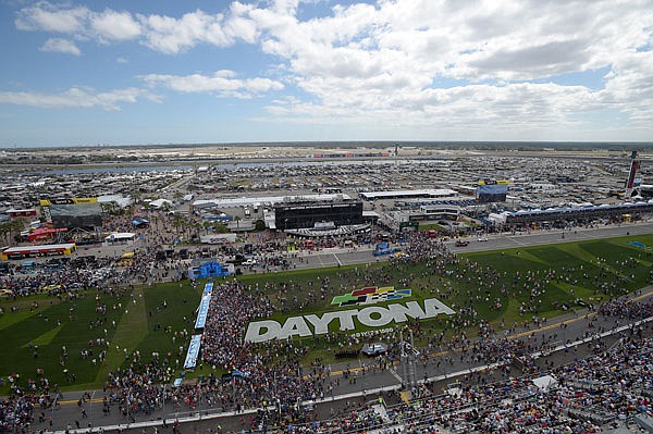 This Feb. 21, 2016, file photo shows fans gathering on the grass in front of the grandstands of Daytona International Speedway before the Daytona 500 in Daytona Beach, Fla. NASCAR is dramatically changing its format for the upcoming season, cutting every race into stages that reward points in hopes of making every lap matter. The overhaul announced Monday assigns three stages to every race, beginning with this year's Daytona 500, which is scheduled for Feb. 26.