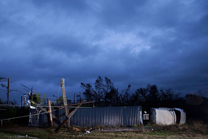 A tractor trailer truck that was damaged by an apparent tornado lays on its side in Albany, Ga. A vast storm system kicked up apparent tornadoes, shredded mobile homes and left other destruction scattered around the Southeast over the weekend.