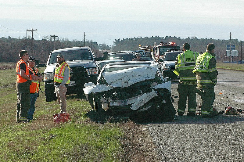 First responders work the scene of a fatal wreck Wednesday, Jan. 25, 2016, about 1.5 miles north of Texarkana, Texas' city limits on U.S. Highway 71. The vehicle was northbound on the highway. Area fire departments directed traffic at the accident scene.