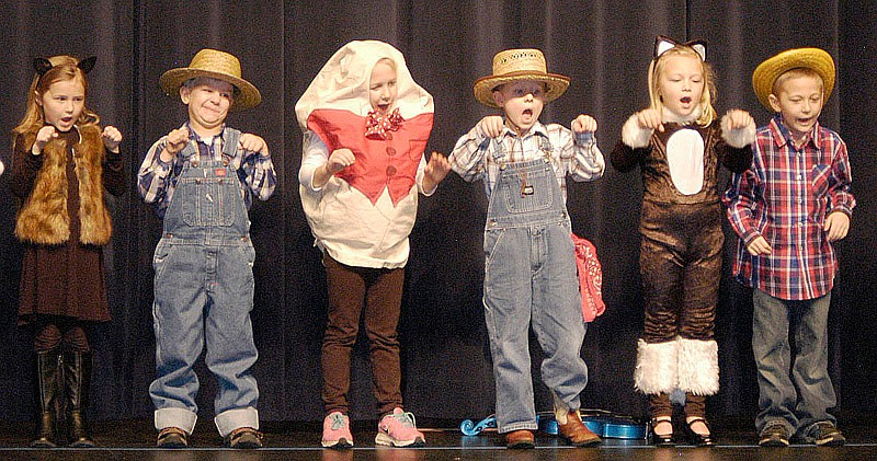Several kindergartners in Jill Kirksey's class pantomime with their recitation of a nursery rhyme.
