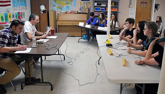 The Tuscumbia Middle School academic bowl team, back, and Holden Middle School team get ready to buzz in as the moderator reads the next toss-up question. The Tuscumbia team won this round of competition Saturday during the Tuscumbia Winter Tournament.