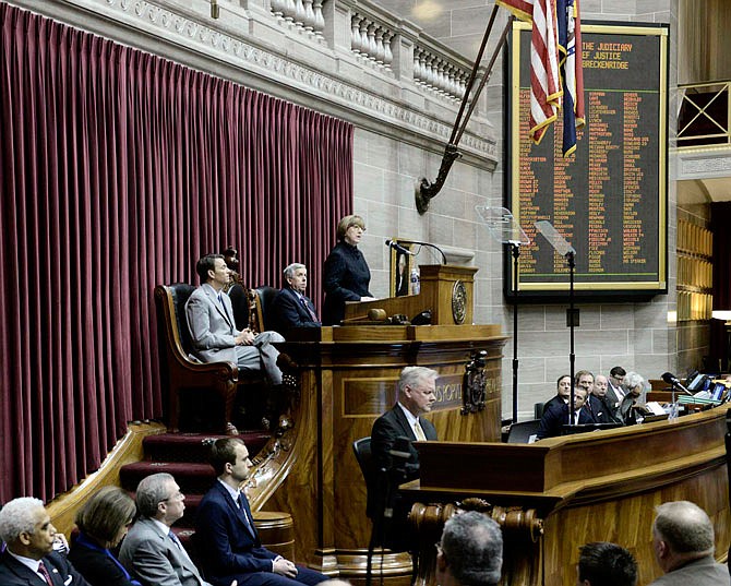 Speaker of the House Todd Richardson, seated at left on dais, and Lt. Gov. Mike Parson, seated in middle, listen as Chief Justice Patricia Breckenridge delivers the annual State of the Judiciary address to a joint session of the Missouri House and Senate Tuesday morning.