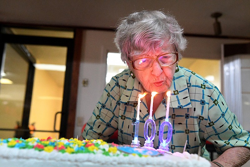 Pauline Kinzie blows the candles out on her birthday cake Wednesday during a surprise party from her family and friends at College Bowl. A bowler and domino player, Kinzie will be celebrating her 100th birthday this Sunday. 