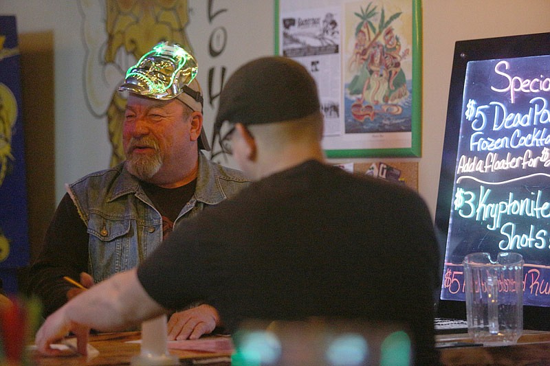 With a light-up skull mask as part of his costume, Don Werdehausem fills out his scavenger form in the Shrunken Head during the start of the Jefferson City Downtown Association's annual pub crawl on February 6, 2016.