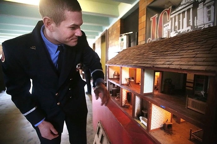 Evan Jennings demonstrates how a 1970's house model taught children about fire safety at the Jefferson City Fire Museum on Wednesday. The museum celebrated 175 years of public fire service by the fire department in Jefferson City.