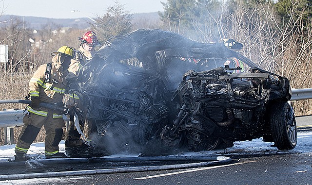 Firefighters extinguish a car that caught fire Wednesday after a multi-vehicle crash along westbound Interstate 70, at the intersection of Interstate 270 in Frederick, Maryland. State Police spokeswoman Elena Russo said the multiple-vehicle crash, which claimed at least one life, occurred as police were assisting U.S. Capitol Police with a motorcade.