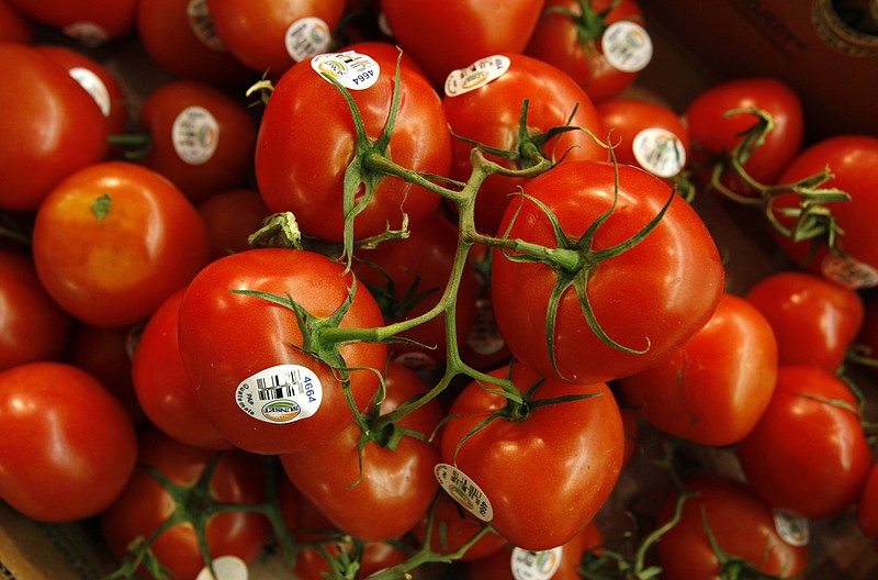  In this March 23, 2011 file photo, tomatoes are seen in the produce section at a grocery store in Des Moines, Iowa. Scientists have cooked up a way to reintroduce a key ingredient into mass-produced tomatoes: taste. Researchers have figured out just the right spots on the genetic blueprint of tomatoes where flavor has been bred out of supermarket tomatoes for the past 40 or 50 years, according to a study in the journal Science. And using natural breeding methods, a little modernized with hand pollination by electric toothbrushes _ they are reinstalling five factors to add aroma and taste into the staple of salads.