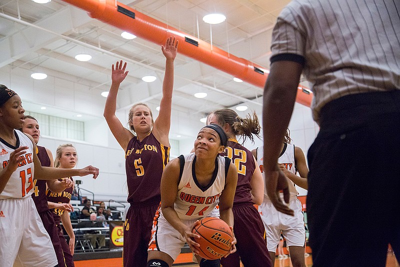 Queen City's Jessica Jones recovers a ball and prepares to shoot against New Boston on Friday in Queen City, Texas.