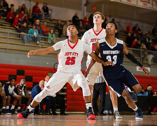 Kamari Balton (left) and Ben Folz (center) of the Jays battle Northwest Academy of Law's Damien Carver for a rebound on a free throw during Friday night's game at Fleming Fieldhouse.