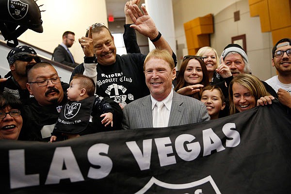 In this April 28, 2016, file photo, Raiders owner Mark Davis (center) meets with Raiders fans after speaking at a meeting of the Southern Nevada Tourism Infrastructure Committee in Las Vegas.