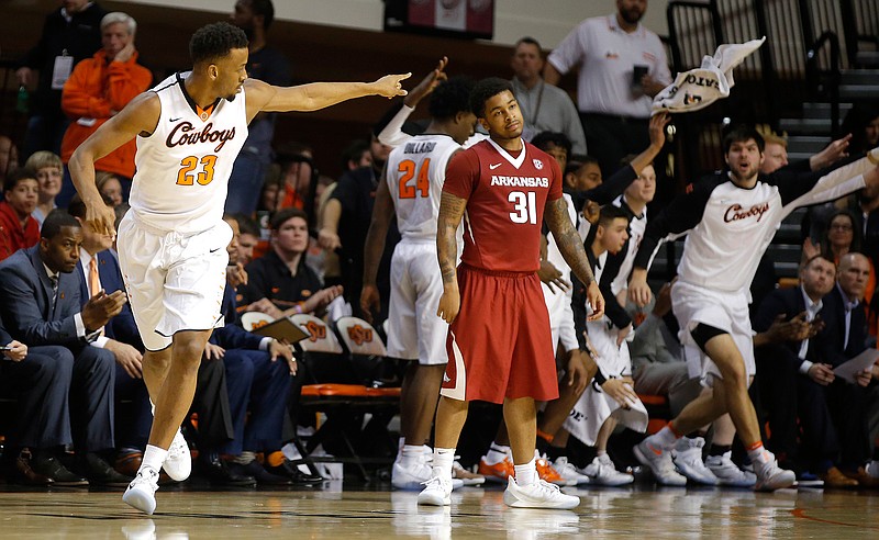 Oklahoma State's Leyton Hammonds (23) celebrates after making a 3-pointer, beside Arkansas' Anton Beard (31) during an NCAA college basketball game in Stillwater, Okla., Saturday, Jan. 28, 2017.