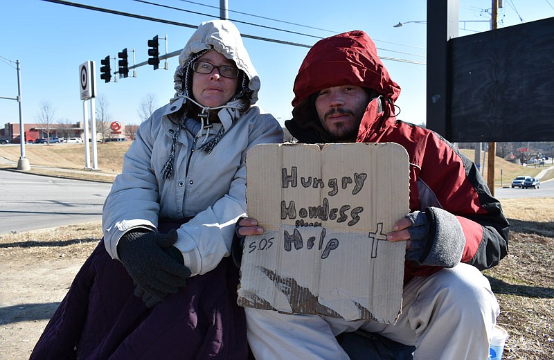 In this January 2017 photo, Lawrence Oker and Janet Harris hold a sign soliciting help from passing motorists in Jefferson City.