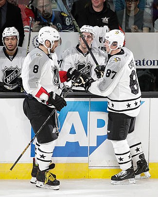 Sidney Crosby (right) celebrates his goal Sunday with Alex Ovechkin during the NHL All-Star game in Los Angeles.