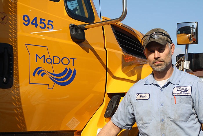 MoDOT mechanic Darrin Johnson stands next to one of the trucks he maintains in Callaway County.