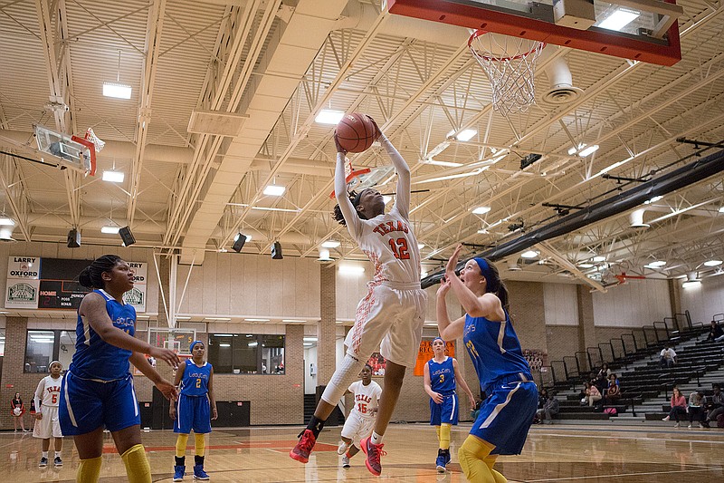 Texas High's Unique McBride shoots over Sulphur Springs' Autumn Tanton on Tuesday in Texarkana, Texas.