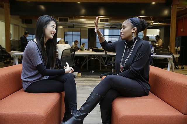 Aniyia Williams, founder and CEO of Tinsel, right, talks about program placement Tuesday with Kara Lee, at the offices of Galvanize in San Francisco. Williams said she has made sure to hire women as well as underrepresented minorities. Tinsel makes tech jewelry targeted at women.