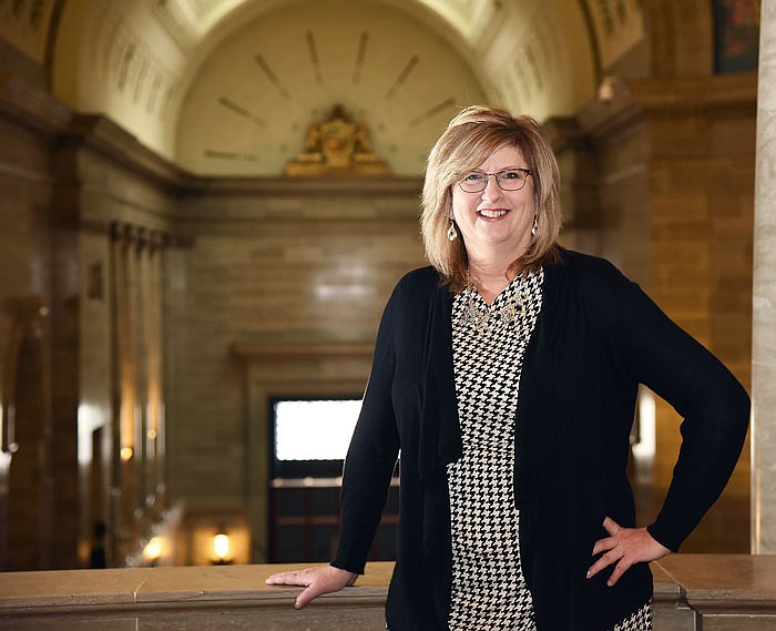 Sherri Kempf stands in the fourth floor walkway of the Capitol.