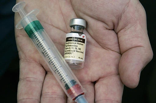 In this Aug. 28, 2006 file photo, a doctor holds a vial of the human papillomavirus (HPV) vaccine Gardasil in his Chicago office.