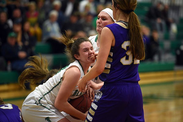 Brooke Boessen of Blair Oaks attempts to get the ball away from Hallsville's Hannah Stephens during Monday night's game in Wardsville.
