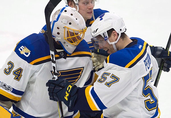 Blues left wing David Perron (57) congratulates goalie Jake Allen on his shutout as the Blues defeated the Senators 6-0 in Tuesday's game in Ottawa, Ontario.