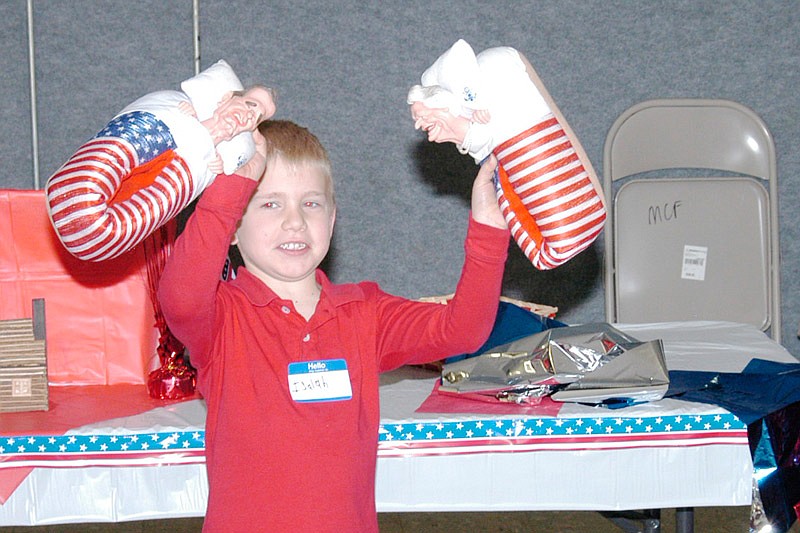 Jamestown kindergartner Isaiah Heimericks shows off the traveling George and Barbara Bush house slippers which he won custody of at the Lincoln Day Dinner Saturday, Feb. 4, 2017. He will pass them on next year to the next winner.