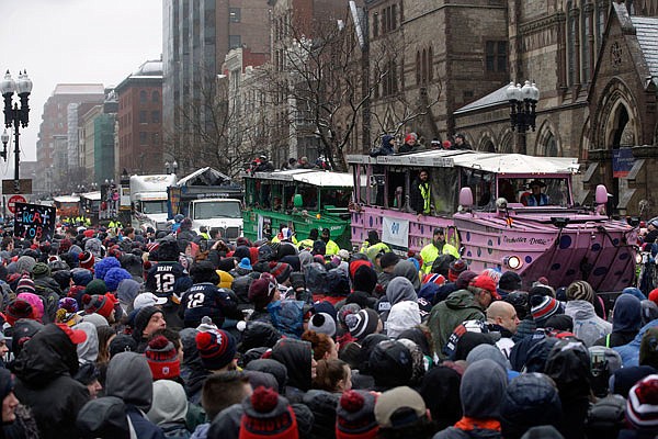 Fans cheer the Patriots riding on duck boats during Tuesday's parade in Boston to celebrate the team's 34-28 win against the Falcons in Super Bowl LI.