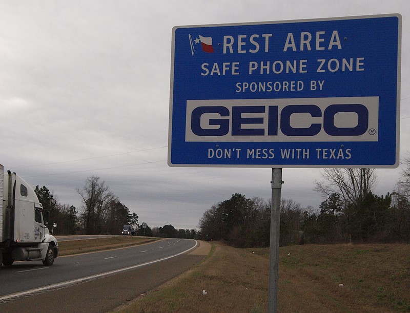 GEICO, the insurance company, is now helping to sponsor Texas highway rest areas and travel centers across the state. This sign is along U.S. Highway 59 in Cass County.