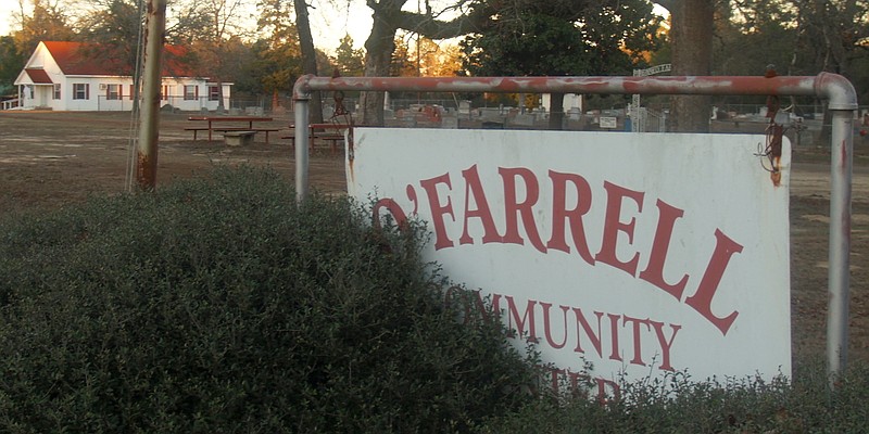 Shrubbery has taken over the O'Farrell Community Center's sign. The community has been without a center for a year after a fire destroyed it.