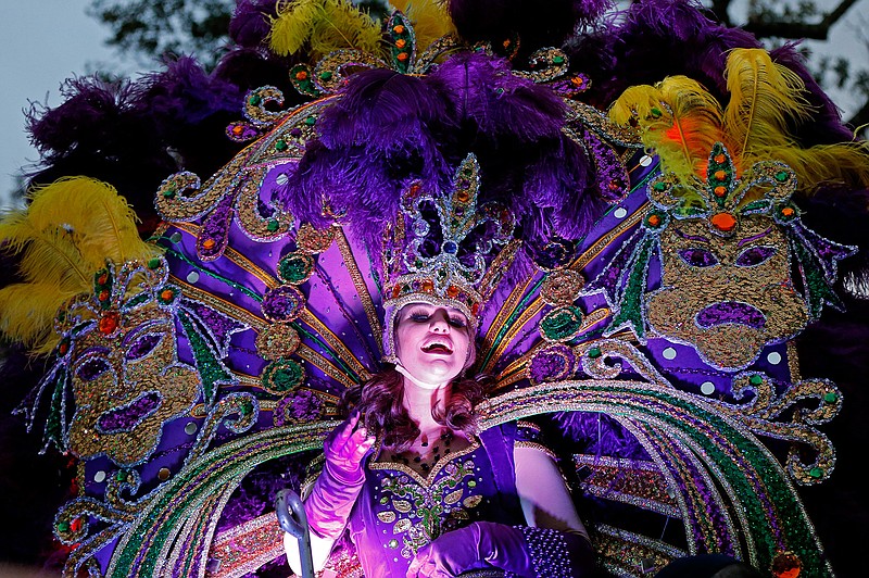 In this Feb. 6, 2016, file photo, a maid from the royal court of Endymion throws beads as the Krewe of Endymion Mardi Gras parade rolls through New Orleans. New Orleans is entering the height of its annual pre-Lenten Carnival season, culminating on Mardi Gras, or Fat Tuesday, which falls on Feb. 28 this year. Travelers to the city face an abundance of choices on how, when and where to take it all in. 