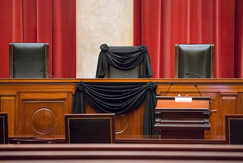 In this Feb. 16, 2016 file photo, Supreme Court Justice Antonin Scalia's courtroom chair is draped in black to mark his death as part of a tradition that dates to the 19th century, at the Supreme Court in Washington. In the year since Scalia's death last February, the court's empty place has often been referred to as "Justice Scalia's seat." But as Supreme Court Justice nominee Neil Gorsuch suggested, the seat's history actually goes back more than 150 years. The lineage includes seven men, all but one nominated to the seat by Republican presidents.