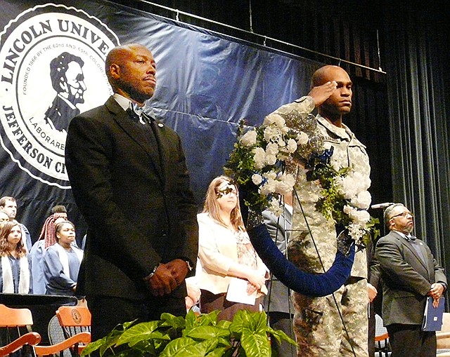 Lincoln University President Kevin Rome, left, stands on stage Thursday next to a wreath and ROTC member during a Founders Day ceremony in Mitchell Auditorium.