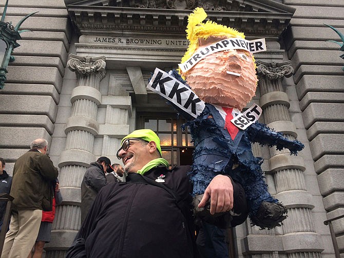 Activity is seen outside the 9th U.S. Circuit Court of Appeals building in San Francisco on Thursday. A federal appeals court refused to reinstate President Donald Trump's ban on travelers from seven predominantly Muslim nations, dealing another legal setback to the new administration's immigration policy. 