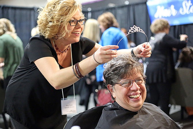 Betty Ann Edelman receives a tiara from Amy Frank during A Night to Shine, sponsored by the Tim Tebow Foundation, on Friday at Capital West Christian Church. The local event was one of more than 300 nationwide proms for people with special needs. The evening was complete with limo rides, dancing, music and hair/makeup makeovers.