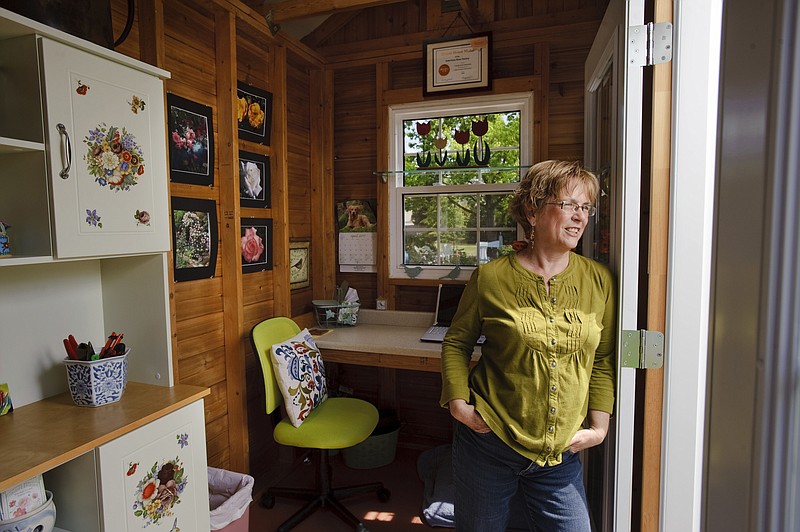 Charlotte Owendyk looks out the double doors of her "Tulip House," a garden building she built from a kit, on April 27, 2011 in Roseville, Calif. It's her garden hide-away and doubles as a home office and gardening shed. 