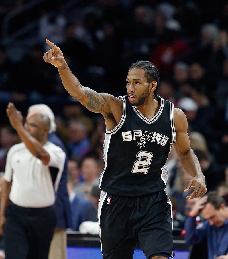 San Antonio Spurs forward Kawhi Leonard points after making a 3-point basket during the second half of the team's NBA basketball game against the Detroit Pistons, Friday, Feb. 10, 2017, in Auburn Hills, Mich. Leonard scored 32 points in the Spurs' 103-92 win.