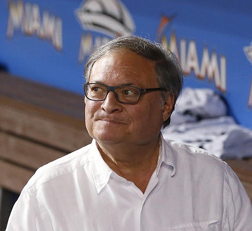 In this May 31, 2016, file photo, Miami Marlins owner and CEO Jeffrey Loria walks through the dugout after a baseball game between the Marlins and the Pittsburgh Pirates, in Miami. A person with direct knowledge of the negotiations says Miami Marlins owner Jeffrey Loria has a preliminary agreement to sell the team to a New York businessman, but the deal could fall through because the final purchase price hasn't been determined.